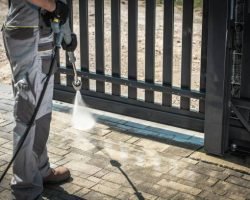 Driveway and a Gate Pressure Washing. Cleaning House Surroundings.